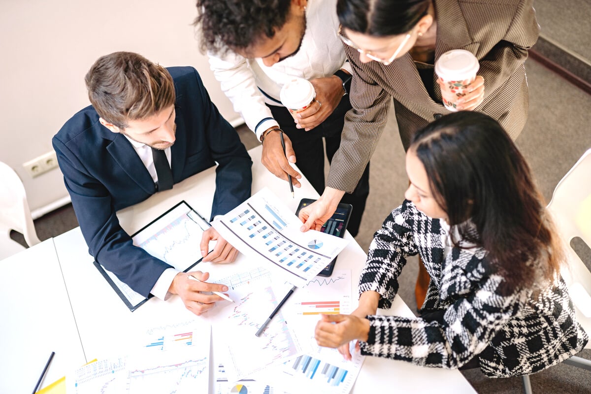 A Group of Business Partner Looking at a Graph Print Out